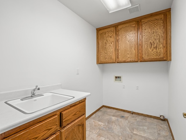 laundry room featuring cabinet space, hookup for a washing machine, and baseboards