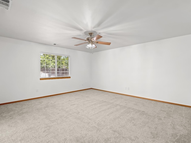 carpeted empty room with baseboards and ceiling fan