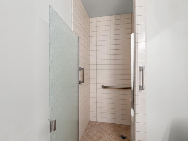 full bathroom with a stall shower and tile patterned floors