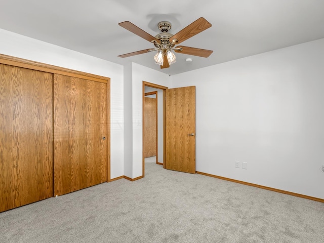 unfurnished bedroom with carpet, baseboards, a closet, and ceiling fan
