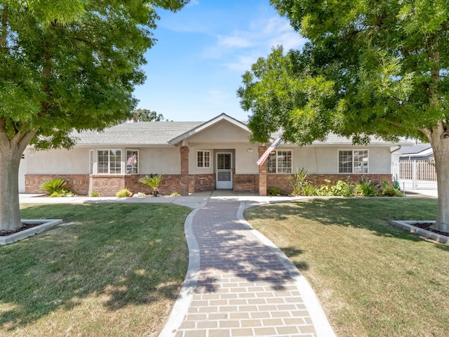 ranch-style house with stucco siding and a front yard