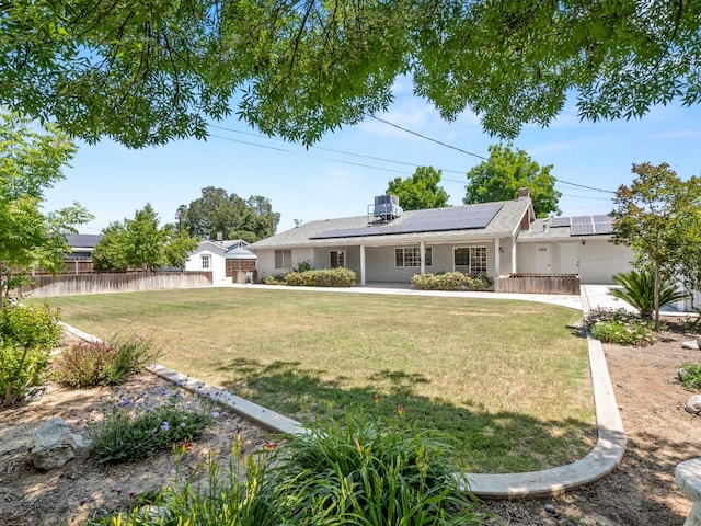 ranch-style house featuring solar panels and stucco siding