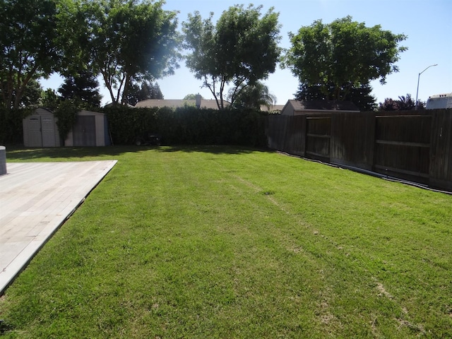 view of yard featuring a shed, an outdoor structure, and central air condition unit