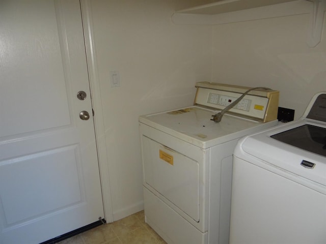 washroom with washing machine and clothes dryer