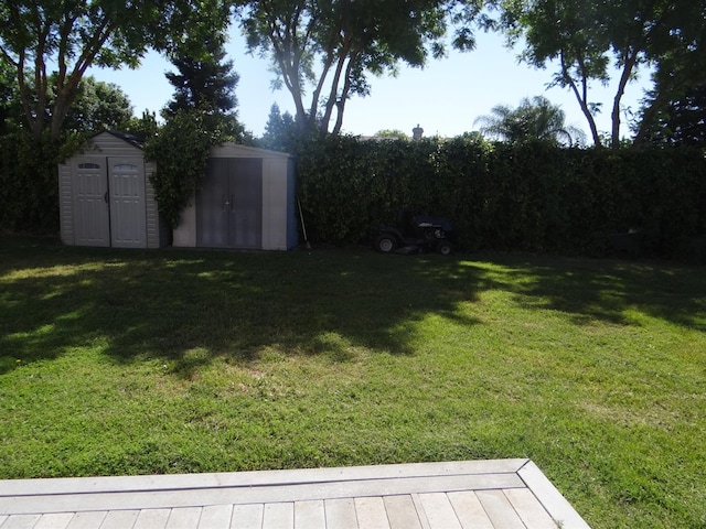 view of grassy yard with a storage unit and an outdoor structure