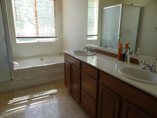 309 Pine Ct, Chowchilla, CA 93610 - full bath featuring a bath, double vanity, a stall shower, and tile patterned floors
