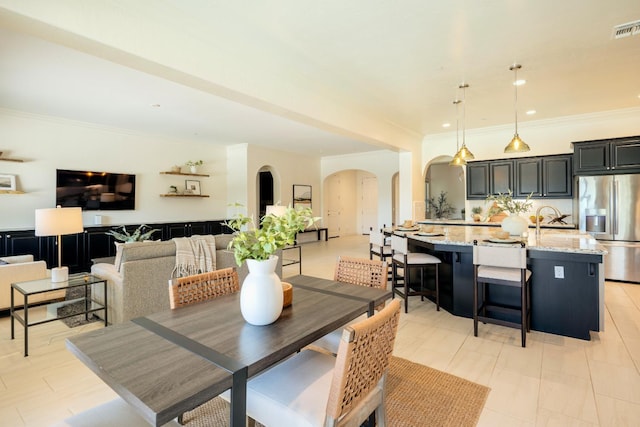 3636 Elberta Cir, Dinuba, CA 93618 - dining area with arched walkways, crown molding, and recessed lighting