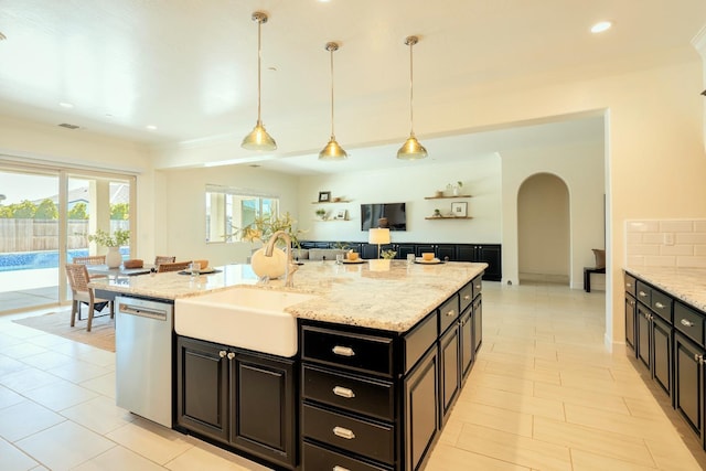 3636 Elberta Cir, Dinuba, CA 93618 - kitchen featuring dishwasher, a sink, arched walkways, ornamental molding, and pendant lighting
