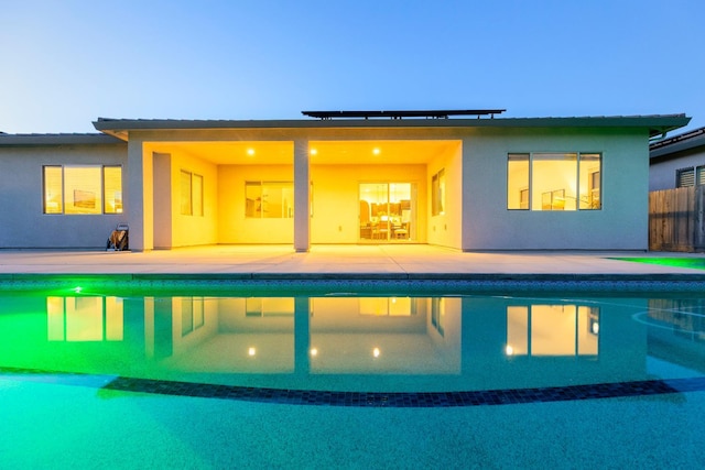 3636 Elberta Cir, Dinuba, CA 93618 - rear view of property featuring an outdoor pool, a patio area, stucco siding, and fence