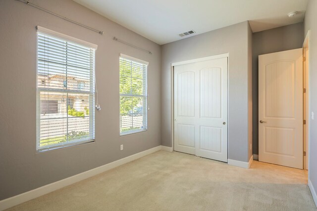 3636 Elberta Cir, Dinuba, CA 93618 - unfurnished bedroom featuring light carpet, a closet, and baseboards