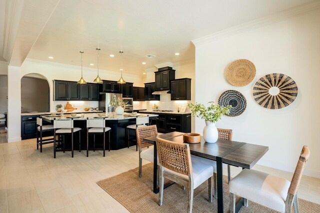 3636 Elberta Cir, Dinuba, CA 93618 - dining space featuring arched walkways, crown molding, and recessed lighting