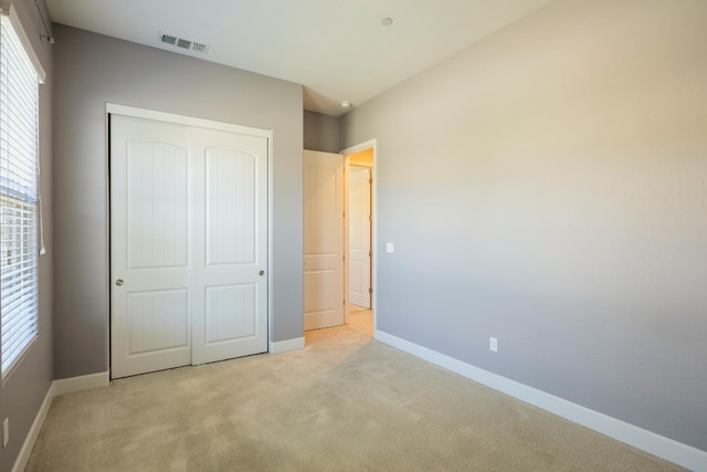 3636 Elberta Cir, Dinuba, CA 93618 - unfurnished bedroom with a closet, multiple windows, carpet floors, and baseboards