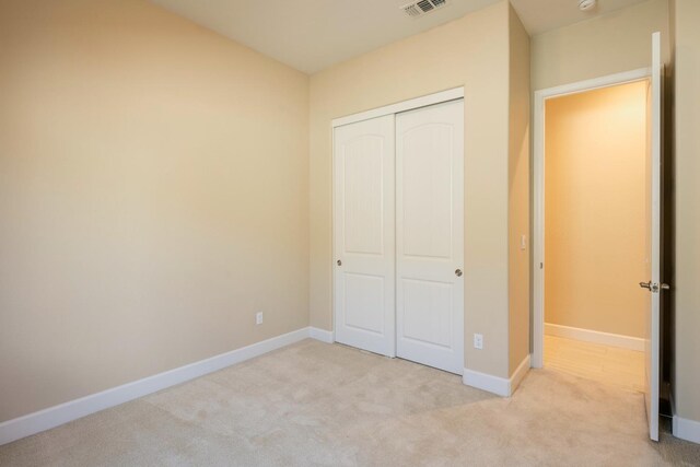 3636 Elberta Cir, Dinuba, CA 93618 - unfurnished bedroom with light carpet, a closet, and baseboards