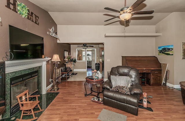 3732 W Garland Ave, Fresno, CA 93722 - living area featuring a ceiling fan, wood finished floors, a fireplace, baseboards, and vaulted ceiling
