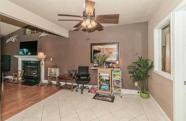3732 W Garland Ave, Fresno, CA 93722 - office space with a textured wall, ceiling fan, tile patterned floors, and a fireplace
