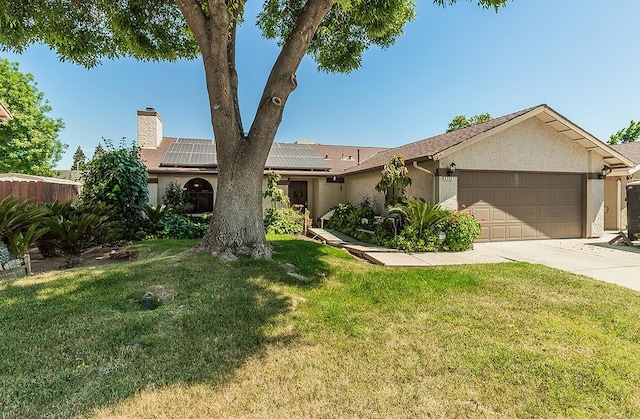 3732 W Garland Ave, Fresno, CA 93722 - ranch-style house with an attached garage, stucco siding, a chimney, roof mounted solar panels, and driveway