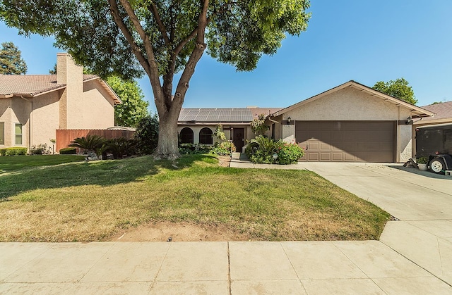 3732 W Garland Ave, Fresno, CA 93722 - single story home featuring a garage, driveway, roof mounted solar panels, and stucco siding