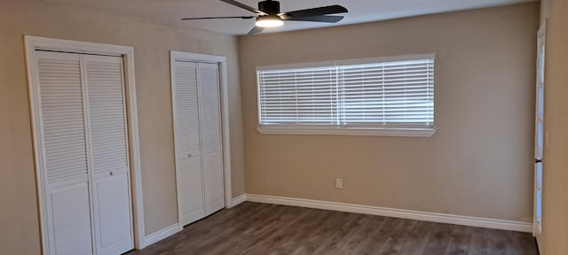 1690 W Wall Ln, Porterville, CA 93257 - unfurnished bedroom with multiple closets, wood finished floors, baseboards, and a ceiling fan