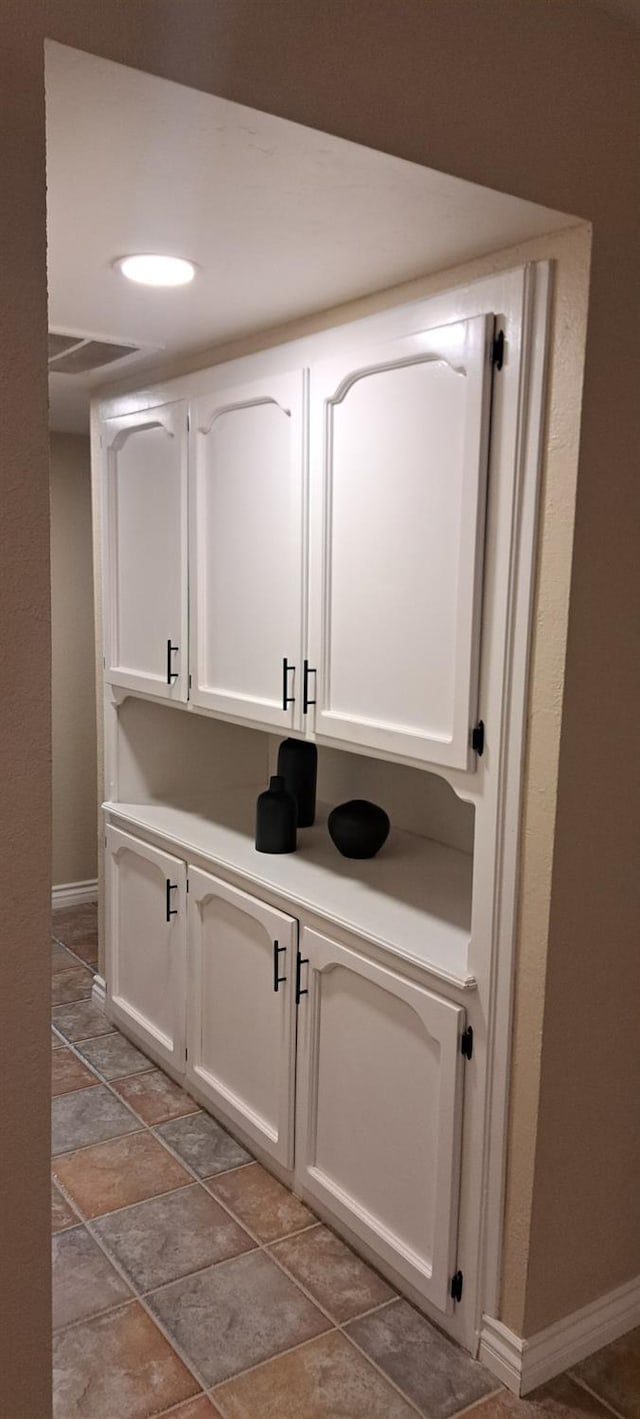 1690 W Wall Ln, Porterville, CA 93257 - bar with baseboards and light stone finish flooring
