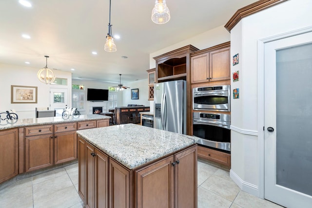 520 W Warwick, Clovis, CA 93619 - kitchen with stainless steel fridge, a warm lit fireplace, a ceiling fan, light tile patterned floors, and recessed lighting