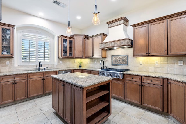 520 W Warwick, Clovis, CA 93619 - kitchen with custom range hood, a sink, open shelves, stainless steel gas cooktop, and light tile patterned floors