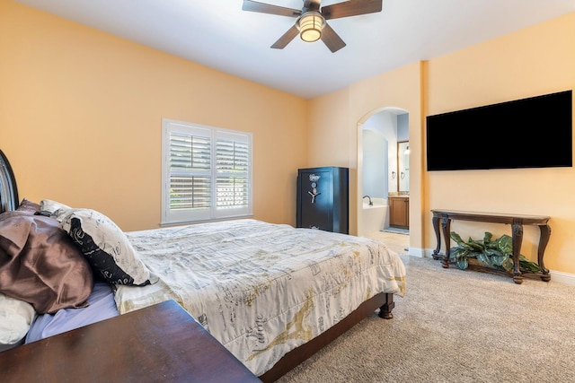 520 W Warwick, Clovis, CA 93619 - bedroom with arched walkways, carpet floors, ensuite bathroom, baseboards, and a ceiling fan