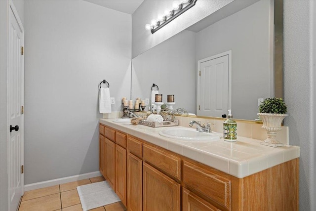 1117 E Royal Dornoch Ave, Fresno, CA 93730 - bathroom with double vanity, tile patterned floors, and baseboards