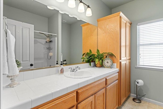 1117 E Royal Dornoch Ave, Fresno, CA 93730 - bathroom with vanity, a shower, baseboards, and tile patterned floors
