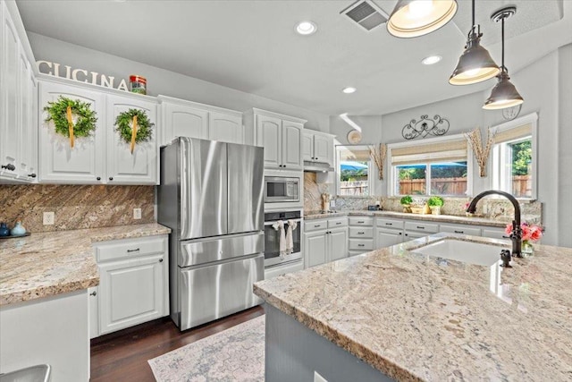 1117 E Royal Dornoch Ave, Fresno, CA 93730 - kitchen featuring stainless steel appliances, a sink, white cabinets, dark wood finished floors, and tasteful backsplash