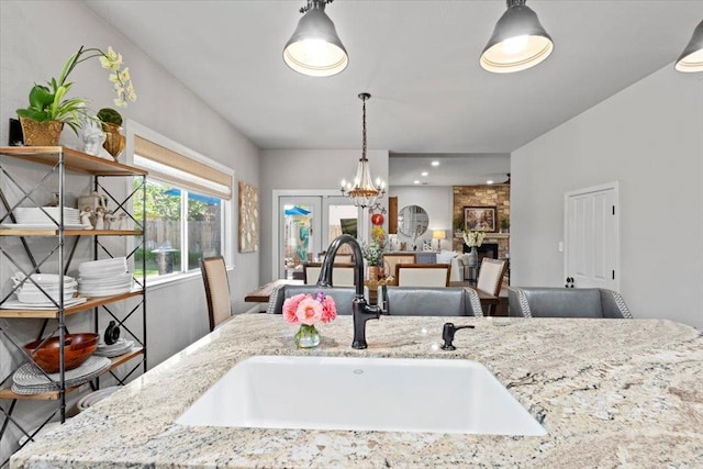 1117 E Royal Dornoch Ave, Fresno, CA 93730 - kitchen featuring a sink, light stone countertops, and pendant lighting
