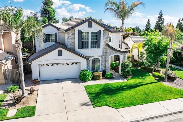 1117 E Royal Dornoch Ave, Fresno, CA 93730 - view of front facade featuring stucco siding, stone siding, driveway, a tiled roof, and a garage