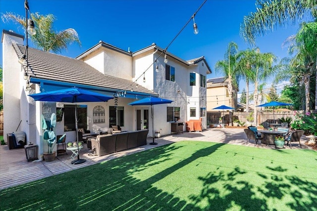 1117 E Royal Dornoch Ave, Fresno, CA 93730 - rear view of property featuring stucco siding, an outdoor living space, a tile roof, and a patio area