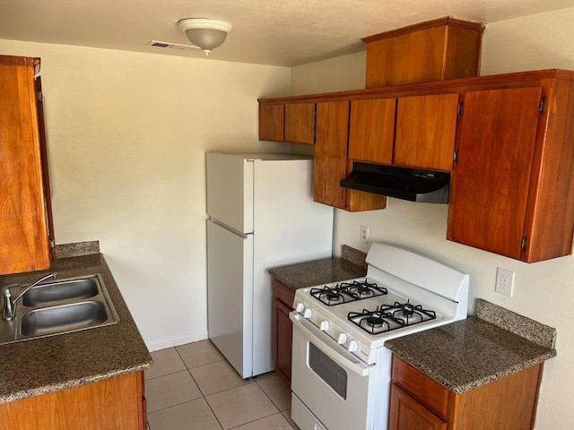 2645 W Robinson Ave, Fresno, CA 93705 - kitchen with white appliances, under cabinet range hood, a sink, and brown cabinetry