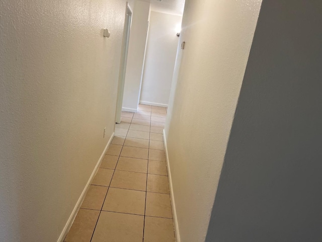 2645 W Robinson Ave, Fresno, CA 93705 - corridor featuring light tile patterned floors, baseboards, and a textured wall