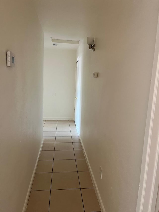 2645 W Robinson Ave, Fresno, CA 93705 - hallway featuring light tile patterned flooring and baseboards
