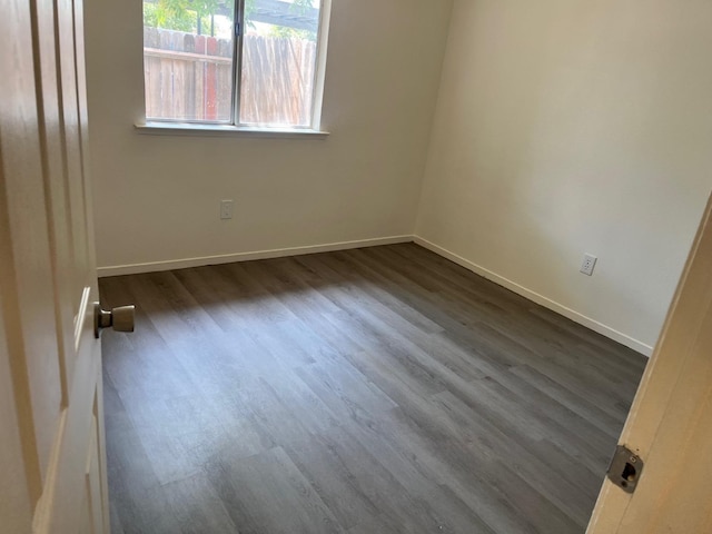 2645 W Robinson Ave, Fresno, CA 93705 - spare room featuring dark wood-type flooring and baseboards