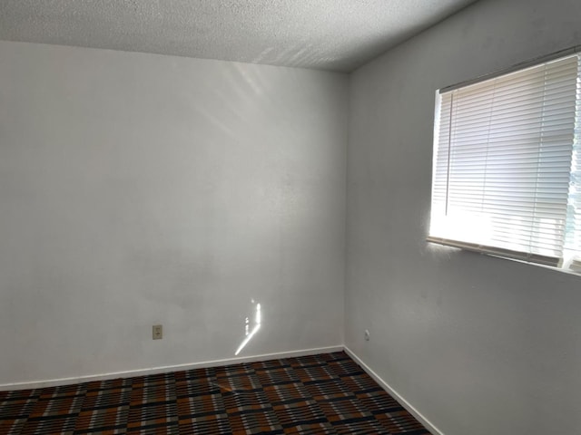 408 S Woodrow Ave, Fresno, CA 93702 - spare room featuring baseboards and a textured ceiling
