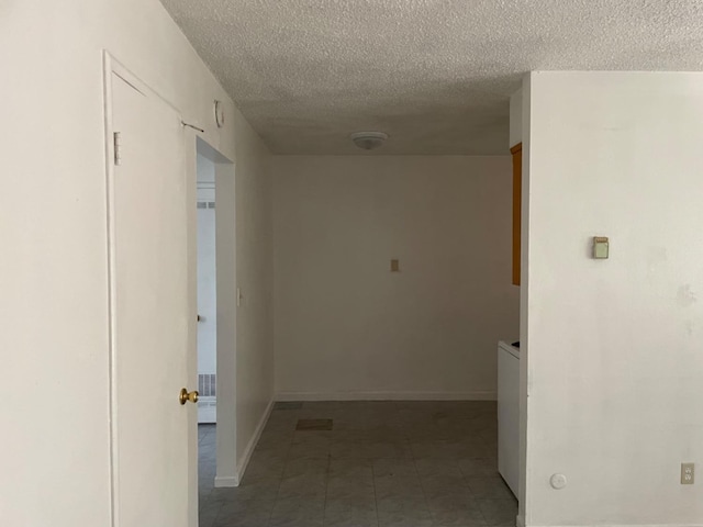 408 S Woodrow Ave, Fresno, CA 93702 - hall featuring a textured ceiling and baseboards