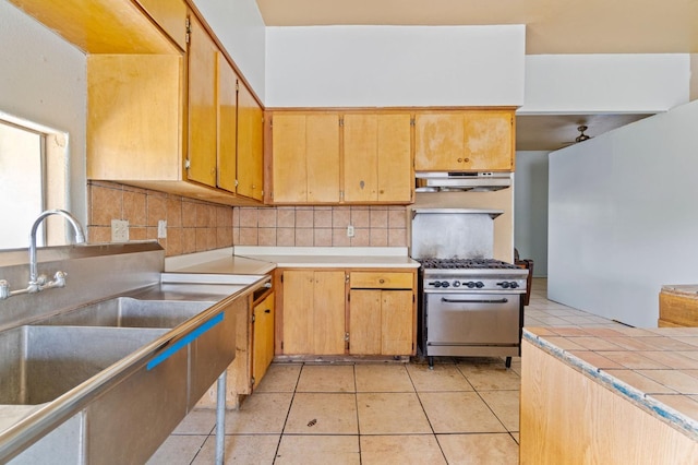 900 Sonora St, Madera, CA 93638 - kitchen featuring high end range, under cabinet range hood, a sink, decorative backsplash, and freestanding refrigerator