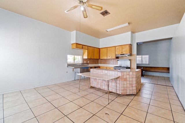 900 Sonora St, Madera, CA 93638 - kitchen with light tile patterned floors, decorative backsplash, light countertops, and a ceiling fan
