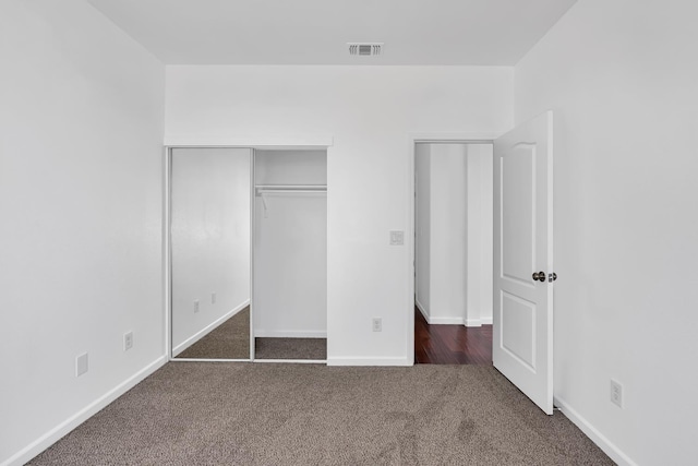 unfurnished bedroom featuring carpet flooring and baseboards