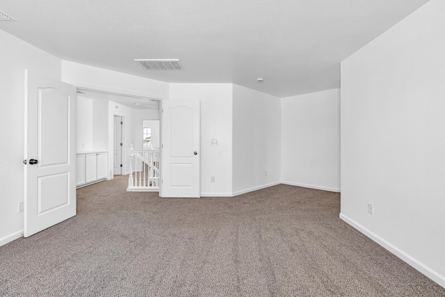 carpeted empty room with baseboards