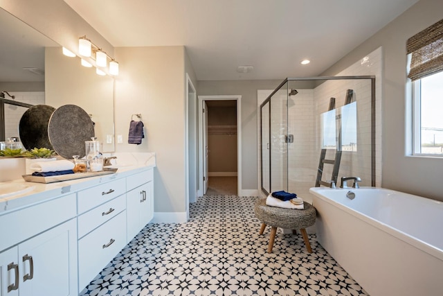 1171 Maclure Ave W, Madera, CA 93636 - full bathroom featuring a shower stall, double vanity, tile patterned floors, a freestanding bath, and a spacious closet