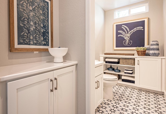 1171 Maclure Ave W, Madera, CA 93636 - bathroom featuring vanity, toilet, tile patterned floors, and a textured wall