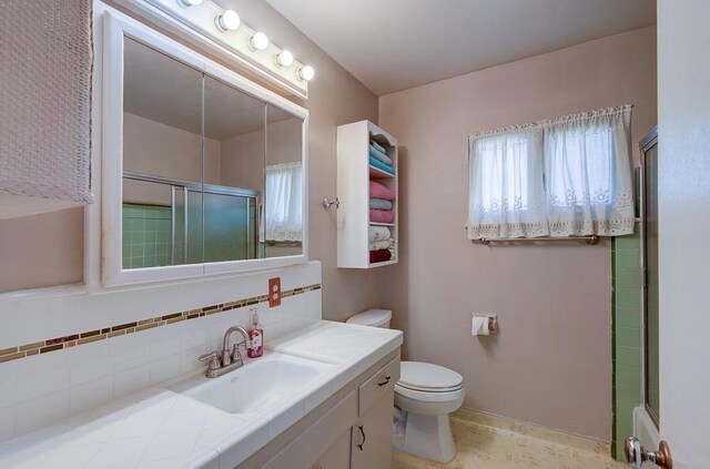 3948 E Fedora Ave, Fresno, CA 93726 - bathroom featuring vanity, a shower with shower door, healthy amount of natural light, and decorative backsplash
