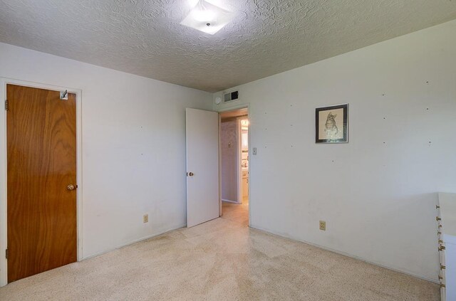 3948 E Fedora Ave, Fresno, CA 93726 - empty room with light carpet and a textured ceiling