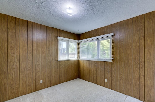 3948 E Fedora Ave, Fresno, CA 93726 - carpeted empty room featuring wood walls and a textured ceiling