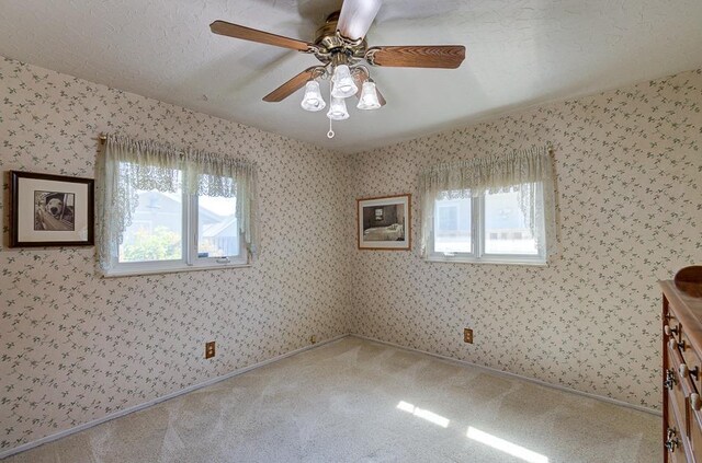 3948 E Fedora Ave, Fresno, CA 93726 - empty room with ceiling fan, carpet, and wallpapered walls