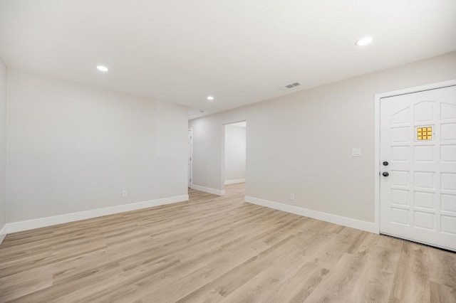 foyer entrance with recessed lighting, light wood-type flooring, and baseboards