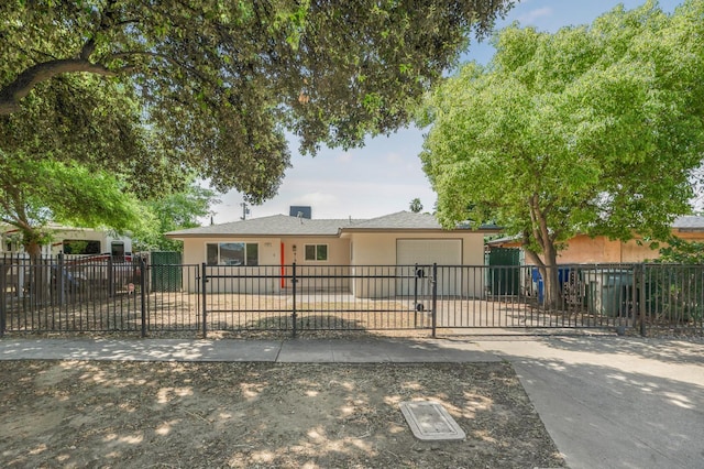 view of front of house featuring stucco siding, an attached garage, concrete driveway, and a fenced front yard